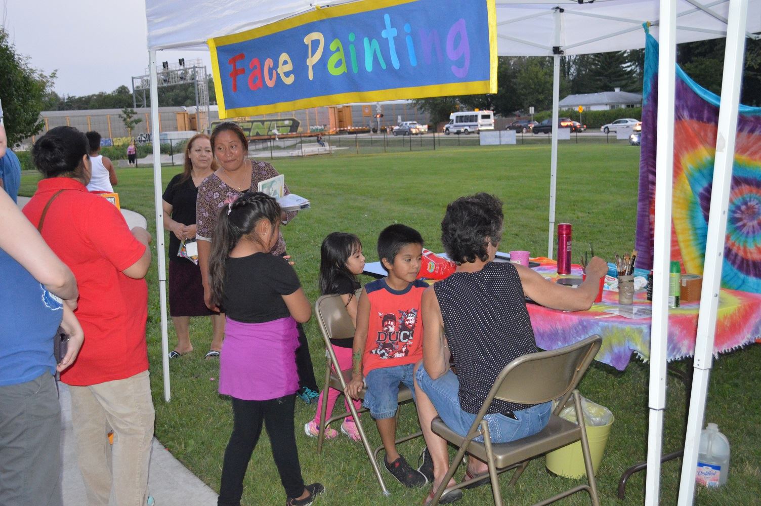 Kids line up to get their faces and arms painted during a National Night Out event at the Iowa Community Center, Aug. 2.